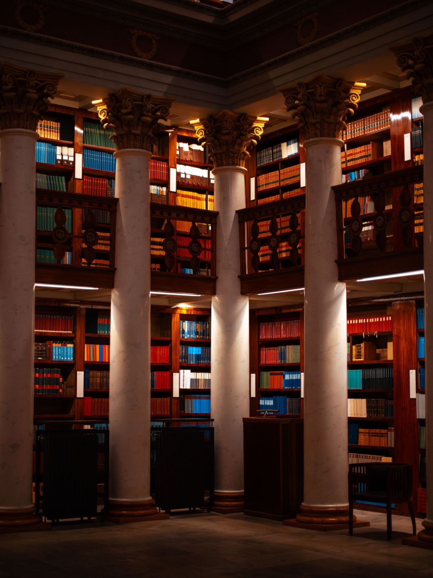 A library interior with marble columns and bookshelves.