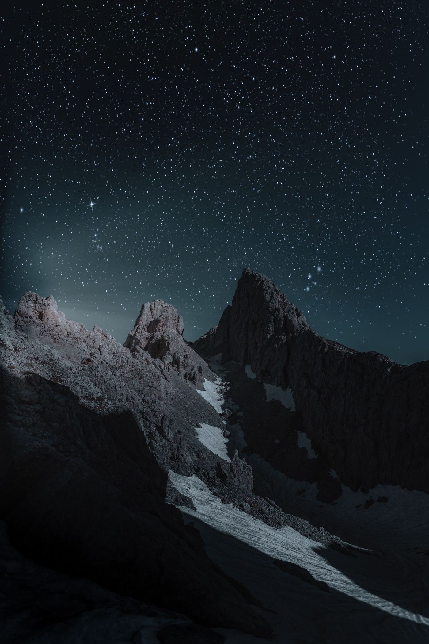 A rocky mountain ridge at night.